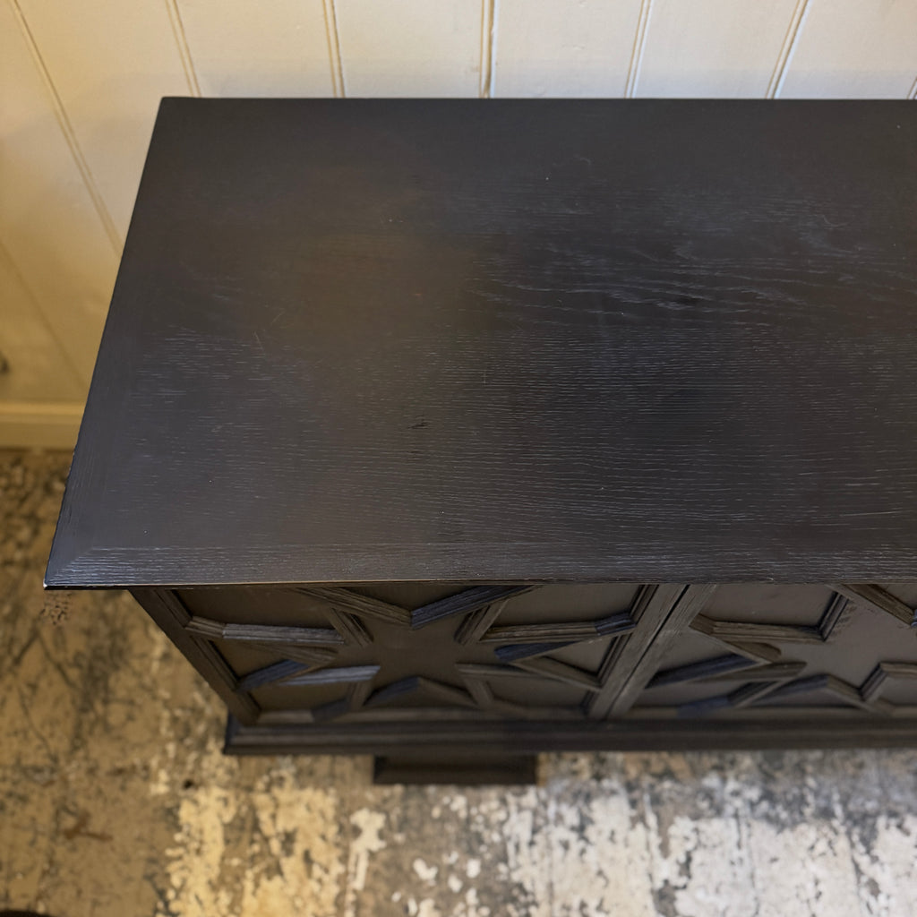 Black decorative cabinet with star patterns, ebonised oak, star motif