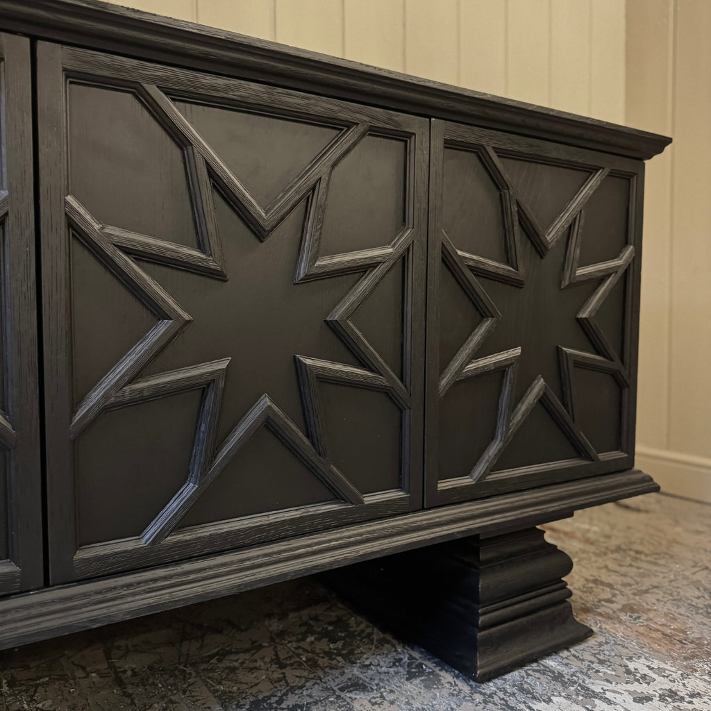 Black decorative cabinet with star patterns, ebonised oak, star motif